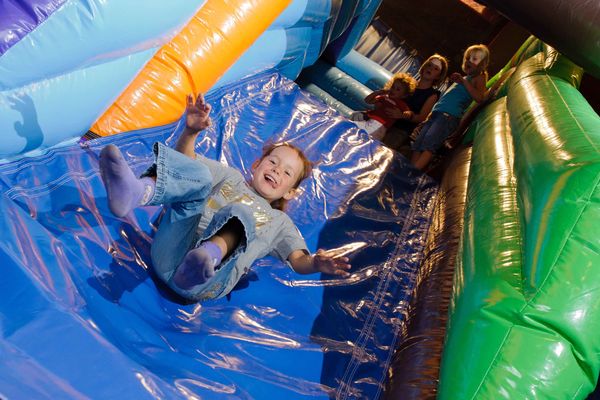 Child on bouncy castle slide