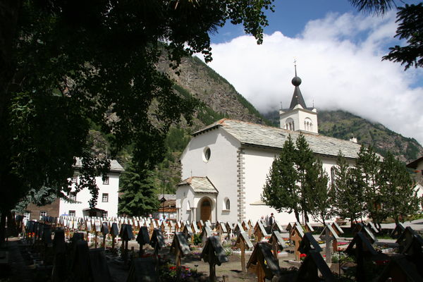 The Roman Catholic church and its cemetery in Täsch, whose wooden crosses carry the names of the faithful departed.