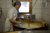Cheese-maker Mirjam Gobba at work at the copper cauldron.