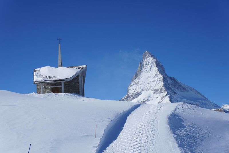 The form of the Riffelberg chapel echoes that of the Weisshorn (right, behind the clouds).
