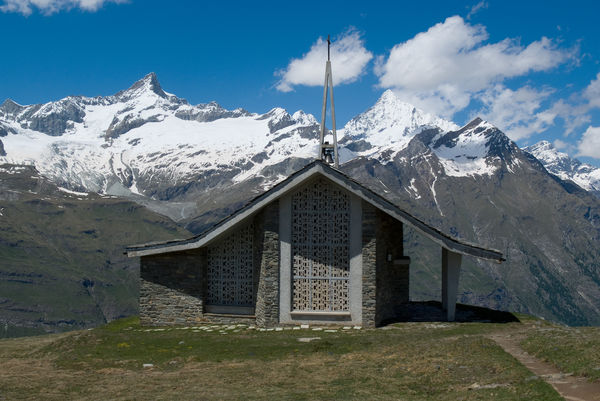 The form of the Riffelberg chapel echoes that of the Weisshorn (right, behind the clouds).