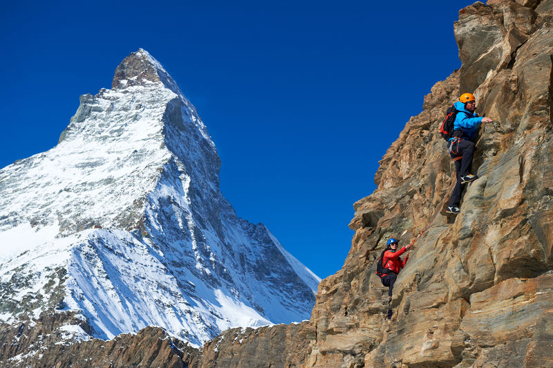 Mountain guide and client, roped up: climbing in Zermatt, in view of the Matterhorn.